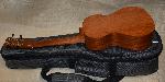 back side of ukulele laying on top of the ukulele carrying case